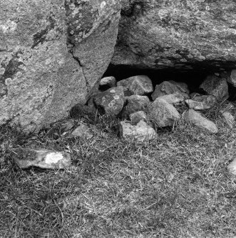 Cobbles beneath the E end of the recumbent stone from the interior, with the E flanker to left