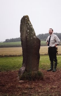 View of rubbing stone from NE, with Dr Iain Fraser (RCAHMS) in picture