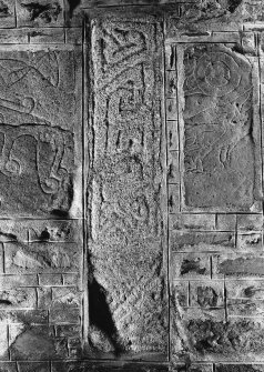 General view of Pictish cross-shaft and stones bearing a cresent and V-rod above a mirror and beast, and half of a double-disc and Z-rod above the body of an eagle.