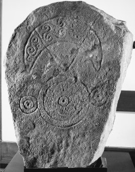 General view of Pictish stone bearing a crescent and V-rod above a triple-disc symbol.