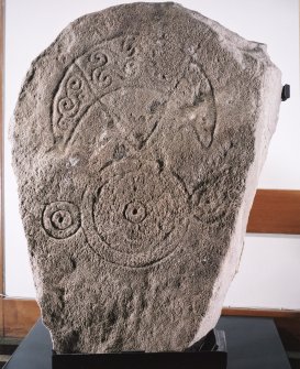 General view of Pictish stone bearing a crescent and V-rod above a triple-disc symbol.