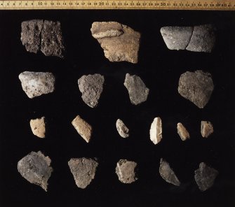 The pottery assemblage and flint scraper from the site.