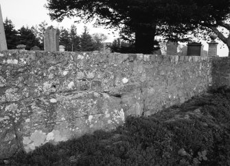 The large stone in the south wall of the churchyard from the west-south-west