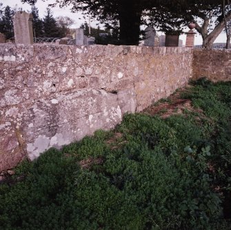 The large stone in the south wall of the churchyard from the west-south-west