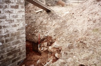 Excavation photograph : wall 12, looking west, also showing machine disturbance.