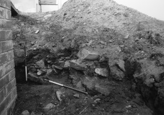 Excavation photograph : detail of wall (12) looking west.