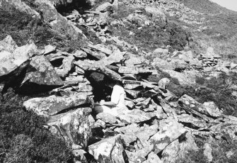 Roofed hut from the west, with Mary Harman.