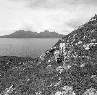 Eigg, Poll Duchaill, Fort. View from S of fragment of W wall.