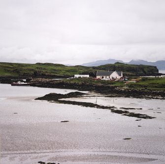 Eigg, Galmisdale Bay. View of fishtrap with pier in the background.