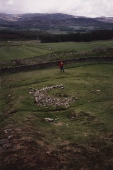 View of three small structures from SE.