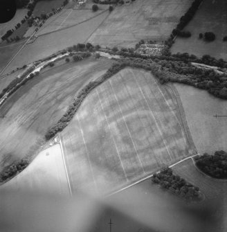 Oblique aerial view centred on the formal garden, farmhouse and farmsteading and the cropmarks of the Roman road, taken from the SE.