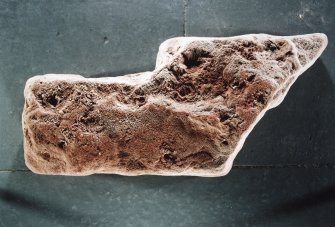 Reverse of fragment of sculptured stone from the foreshore, Inchcape Park, Arbroath, showing possible traces of cross.