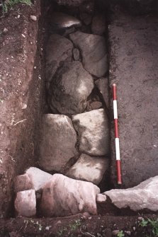 View from W of paving at N end of the excavation trench. Scale in 200mm divisions