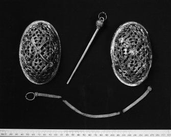 Two Oval Brooches, Silver Pin with filigree head and silver  wire chain (NMA No? 1877) RCAHMS 1982