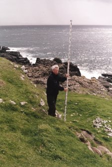 Muck, Caisteal an Duin Bhain. Fort. Site survey in progess. Steve Boyle with the staff.