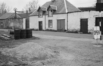 View of cottage with adjoining wall, Lochgilphead Road, Inveraray, next to Semple's Garage.
