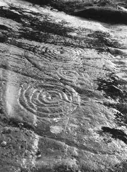 Detail of cup and ring marks on lower sheet.