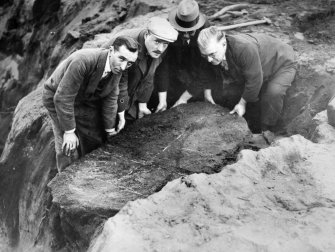 Excavation photograph; cist number 8 - lid about to be removed.
