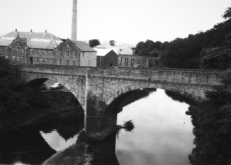 View from SE of Chirnside Bridge and the right wing of the S elevation of the mill behind.