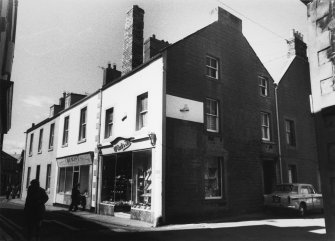 From SE, showing S and E elevations of WM Scott and Son and shop front of Dispensing Chemist.