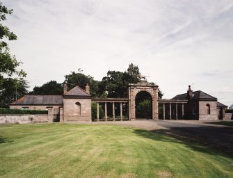 Lion gate, screen wall and cottages. View from WSW