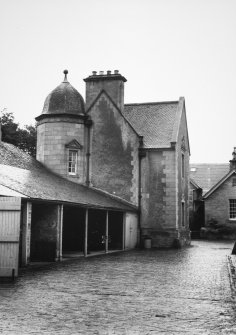 View of cobbled yard and garages.