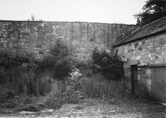 View from E of garden wall in inner courtyard of stables.
