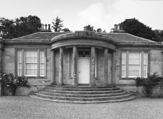 View of frontage and bowed columned entrance porch from S