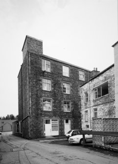 View from N looking into Botany Lane, with four-storeyed mill building (centre).