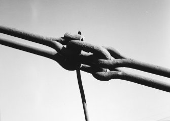 Detail of chain links and part of suspension rod.