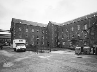 Selkirk, Dunsdale Haugh, Dunsdale Road, Riverside Mills
View from north north west of north east side of original spinning mill, showing its 'T'-shaped plan, its north-east leg being visible to the left, and north-west leg to the right . At the time of the survey, the mill was used predominantly as a warehouse.