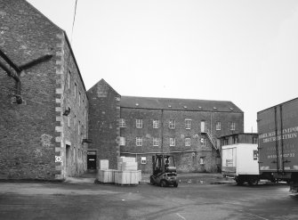 Selkirk, Dunsdale Haugh, Dunsdale Road, Riverside Mills
View from north east of north east side of original spinning mill, showing its 'T'-shaped plan, its north-east leg being partly visible to the left, and north-west leg to the right . At the time of the survey, the mill was used predominantly as a warehouse.