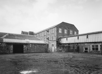 Selkirk, Dunsdale Haugh, Dunsdale Road, Riverside Mills
View from east of overhead gantry carrying passageway from Original Mill to New Mill (centre), with Teasing Department (situated to north west side of former engine house) visible to left
