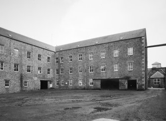 Selkirk, Dunsdale Haugh, Dunsdale Road, Riverside Mills
View from west of south west side of original spinning mill, showing its 'T'-shaped plan, its north-west leg being partly visible to the left, and south-west leg to the right . At the time of the survey, the mill was used predominantly as a warehouse.