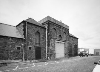 View from S of Engine and Boiler Houses situated at the N end of the SE side of the mill.  Note that the scaffolding was being erected to allow contractors to remove the Aimers & McLean of Galashiels cast-iron water tank on top of the engine house.