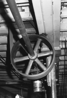 Interior.
Mule mill, first floor, detail of overhead lineshaft and pulley driving mules.