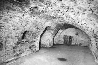 Interior.
Ground floor, central vaulted chamber, S wall from NE.