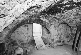 Interior.
Ground floor, SE barrel vaulted chamber, detail of kitchen fireplace in E wall during reconstruction.