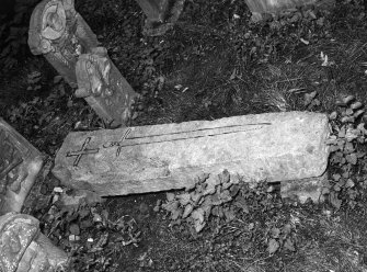 View of gravestone with cross and sword.