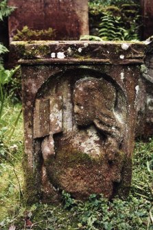 Minto House, Church and Graveyard.
18th Century gravestone for Agnus Madar, her spouse Will Turnbull,  Andre Turnbull his son and Agnus Turnbull their daughter. View of front of gravestone depicting a person holding a book.