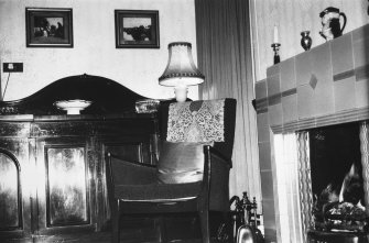 Interior.
View of living room showing chimneypiece, chair and sideboard.