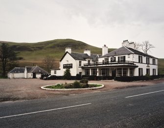View from SE showing main entrance and service buildings.