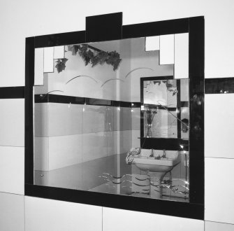 Interior.
Ladies' toilet, detail of mirror etched with a fish on a line.