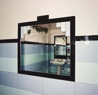 Interior.
Ladies' toilet, detail of mirror etched with a fish on a line.