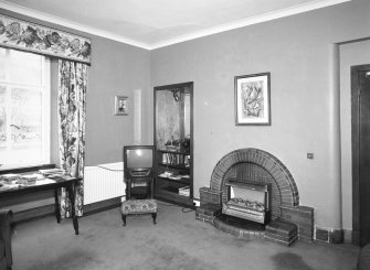 Interior.
Private sitting room, view from NW showing 1930's brick fireplace.