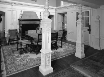 Interior. Entrance hall, view from under colonnaded passage towards fireplace