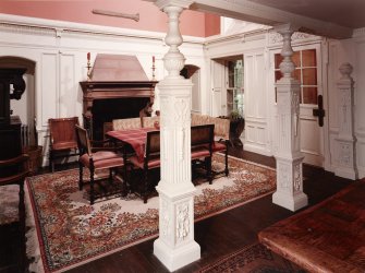 Interior. Entrance hall, view from under colonnaded passage towards fireplace