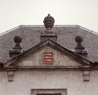 North facade, detail of pediment with heraldic plaque and datestone insc: '1753'.