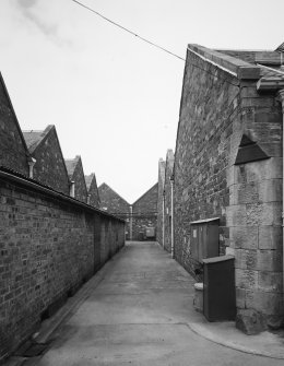 Peebles, March Street, March Street Mills
View from south in passage between central block of mill (right) and north end of main block (left), with north block of mill in backgrounding