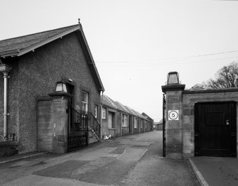 Peebles, March Street, March Street Mills
View from south east of main gate piers, and the east side of the main (south) block of the mill, which dates from c.1930.  Much of the remainder of the mill dates from the 1880s